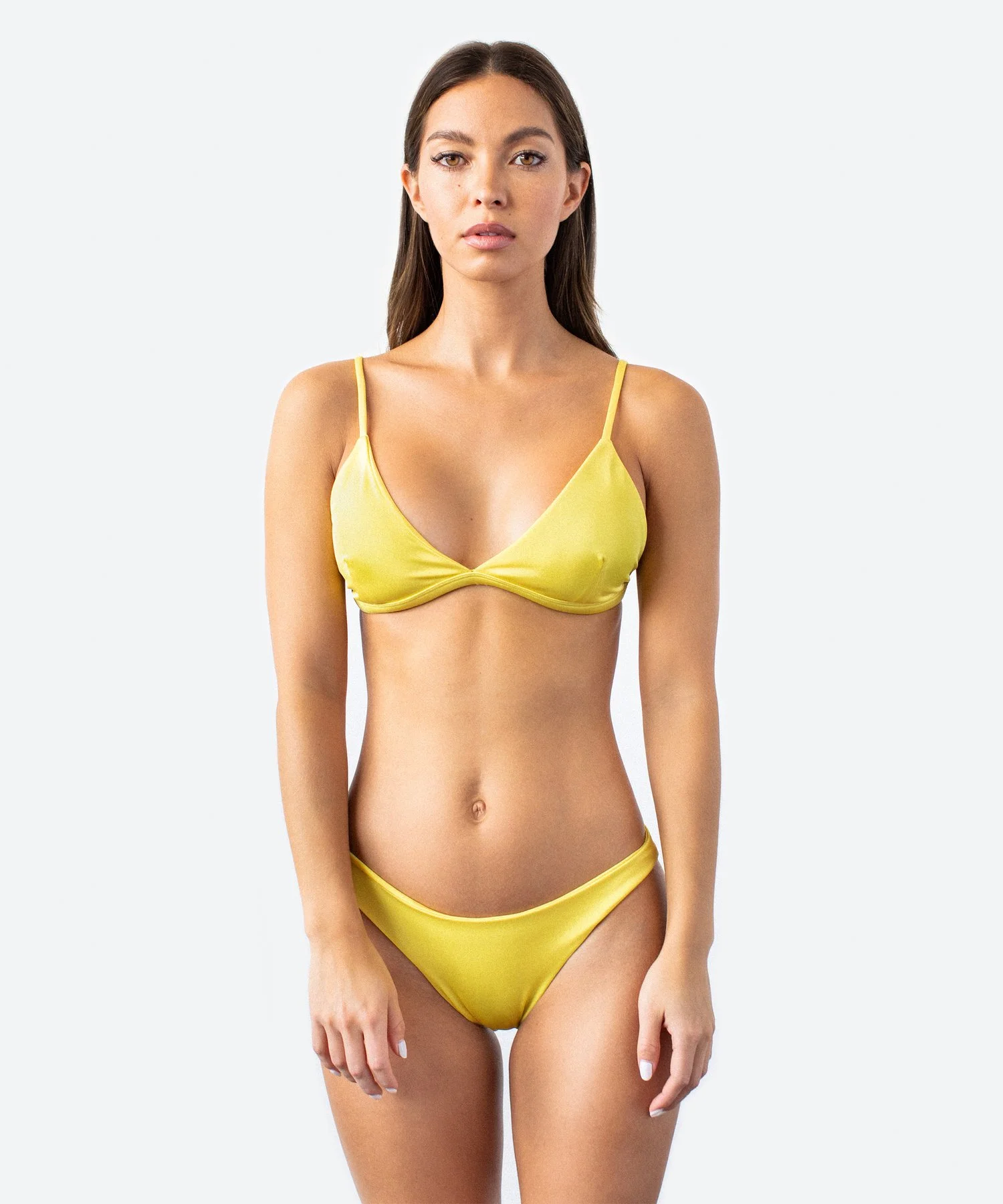 A woman wearing a yellow bikini standing against a plain background.